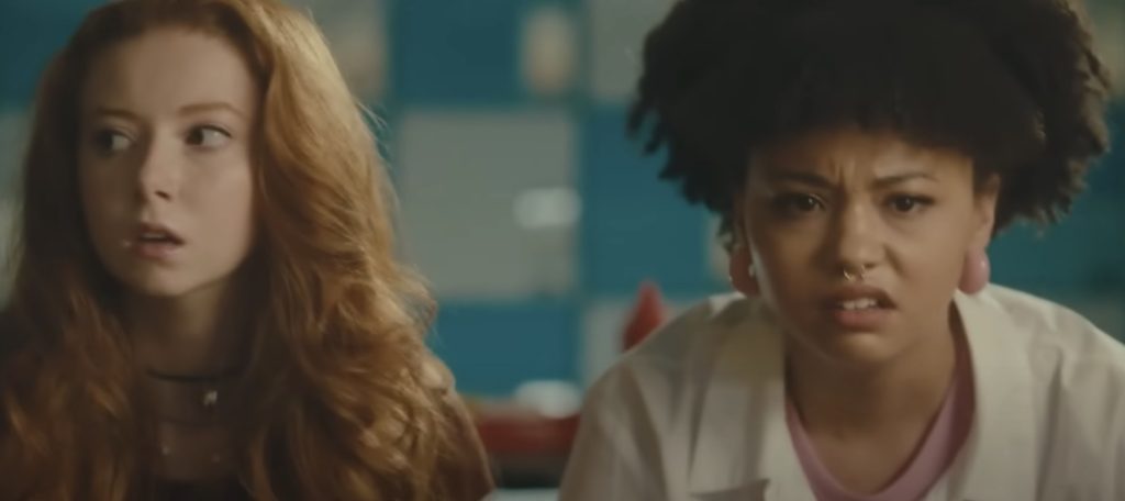 The two main girls watching the mayhem.